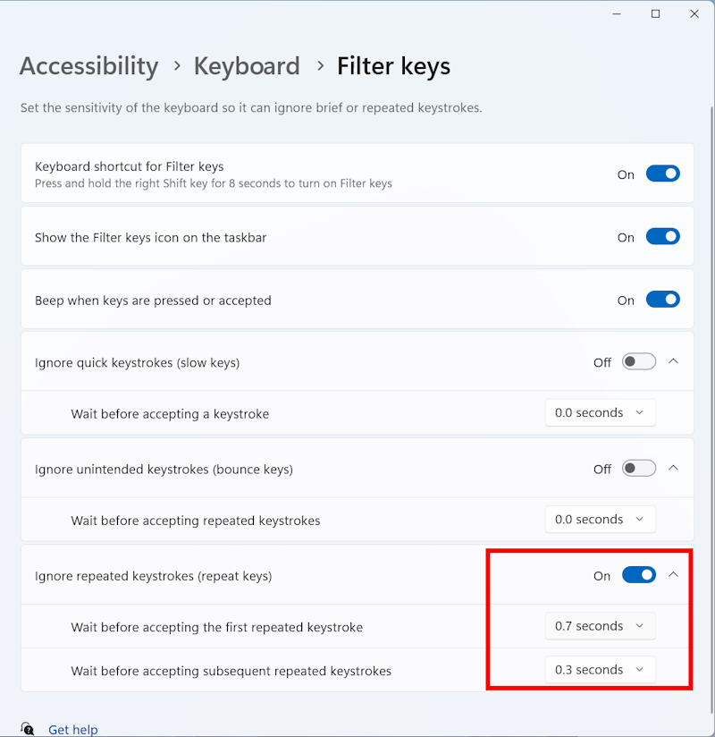 Click the toggle switch to enable Ignore repeated keystrokes. Click the down arrow to adjust the two timer settings.